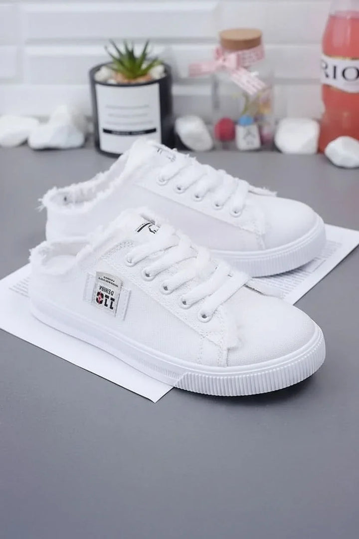 Back view of sleek unisex high-top sneakers, featuring a clean design ideal for everyday casual footwear.