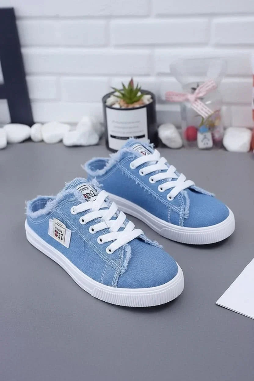 Close-up of durable canvas fabric on a high-top unisex sneaker, showcasing quality material for casual footwear.