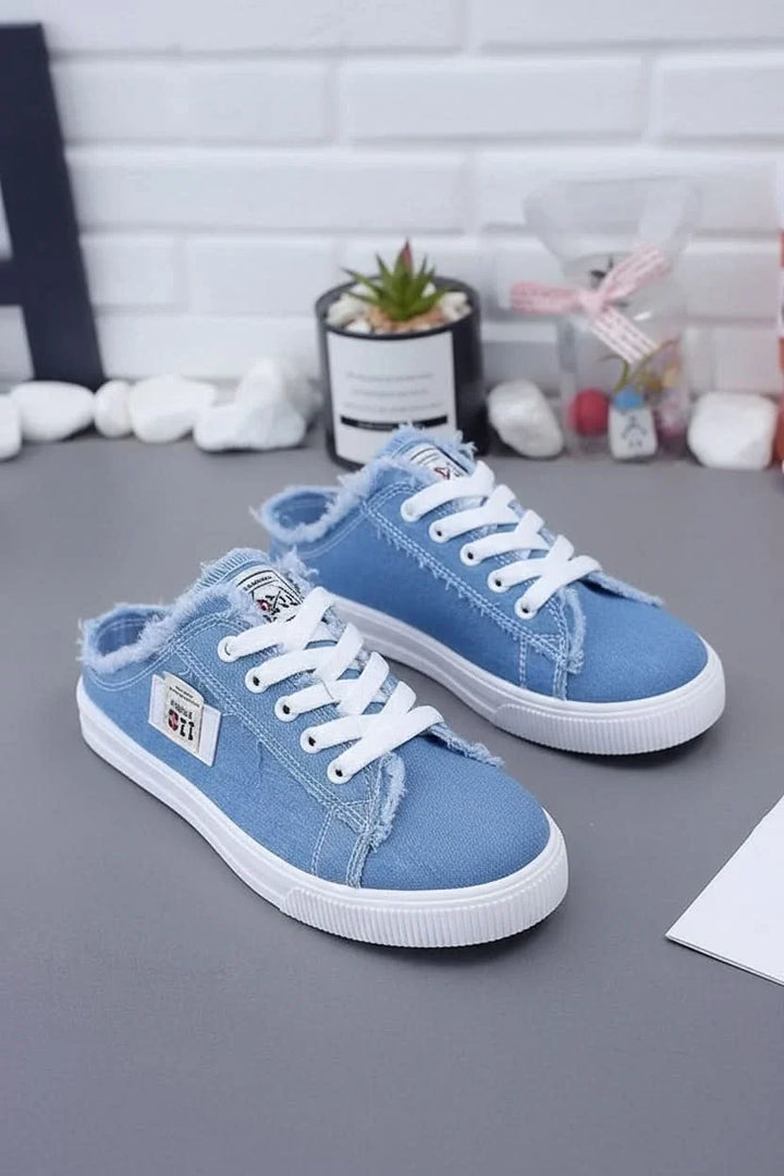 Close-up of durable canvas fabric on a high-top unisex sneaker, showcasing quality material for casual footwear.