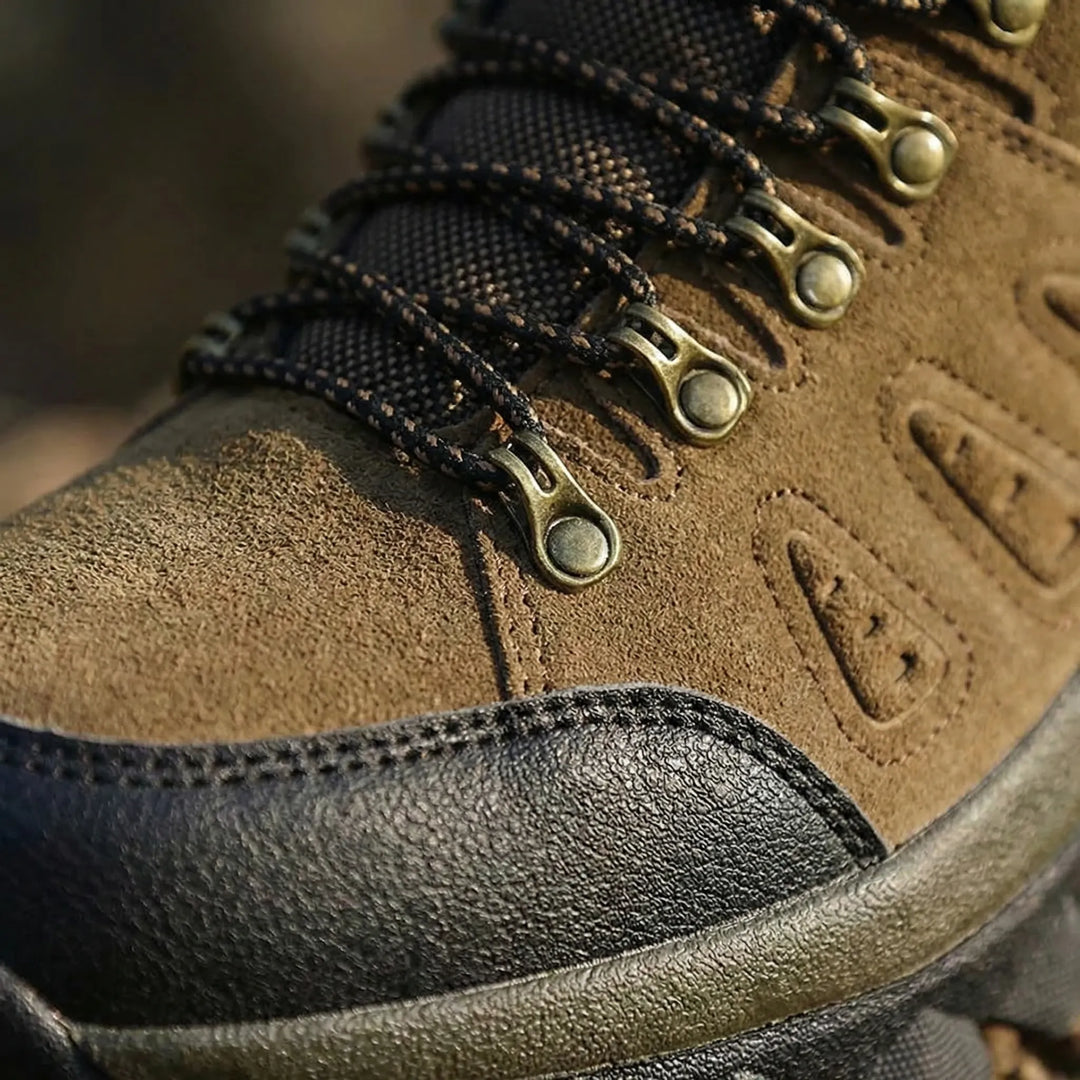 Lace-up high-top hiking boots, unisex outdoor trail shoes offering foot support for rugged adventure gear.