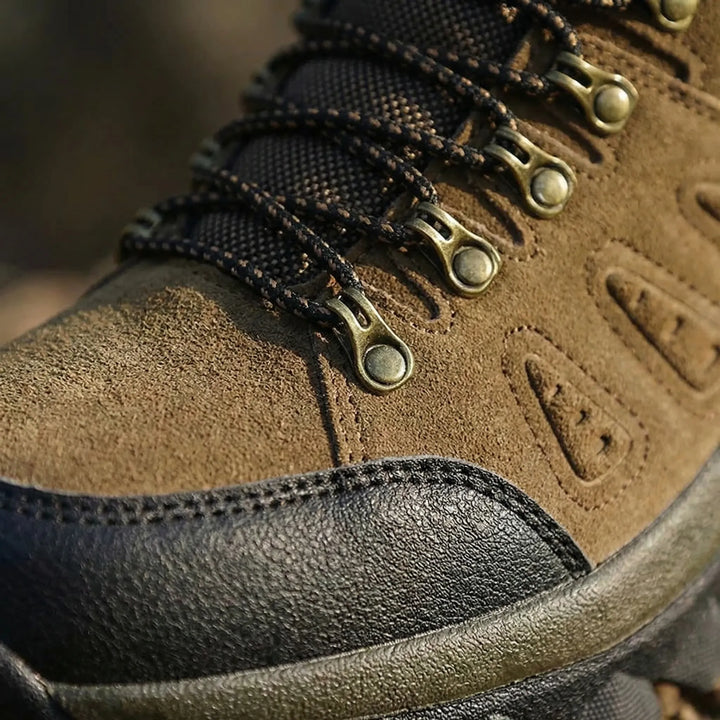 Lace-up high-top hiking boots, unisex outdoor trail shoes offering foot support for rugged adventure gear.