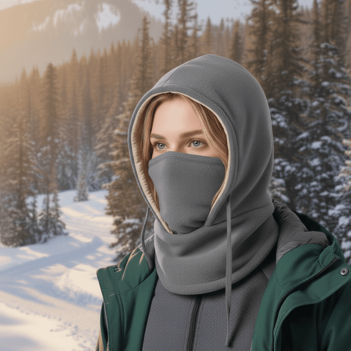 Model wearing a grey unisex hooded neck gaiter, suitable for cold weather hiking, cycling, and winter sports.