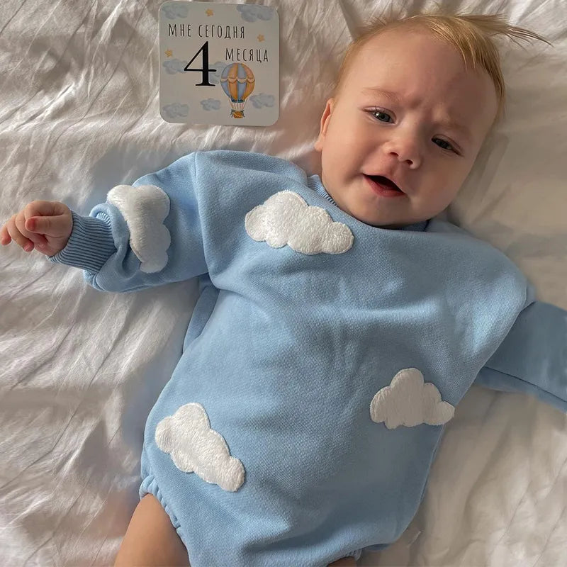 Baby's white cotton romper with blue cloud print, comfortable infant jumpsuit for everyday wear.