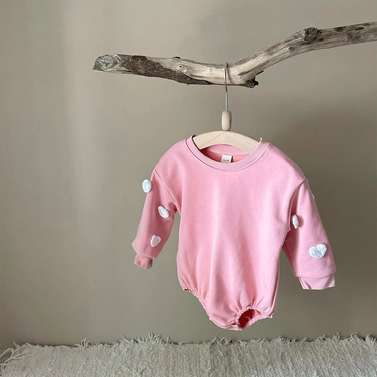 Stylish baby romper with a subtle cloud pattern, made from high-quality soft cotton.