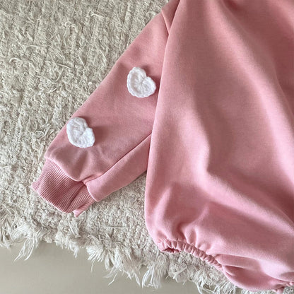 Delicate cloud print on a pure cotton baby romper, emphasizing softness and gentle design.
