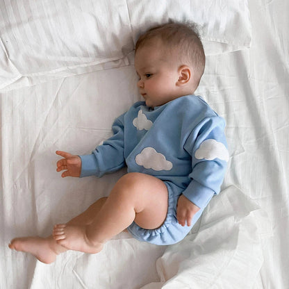 Infant baby jumpsuit made of breathable cotton with playful cloud print, easy to wear.