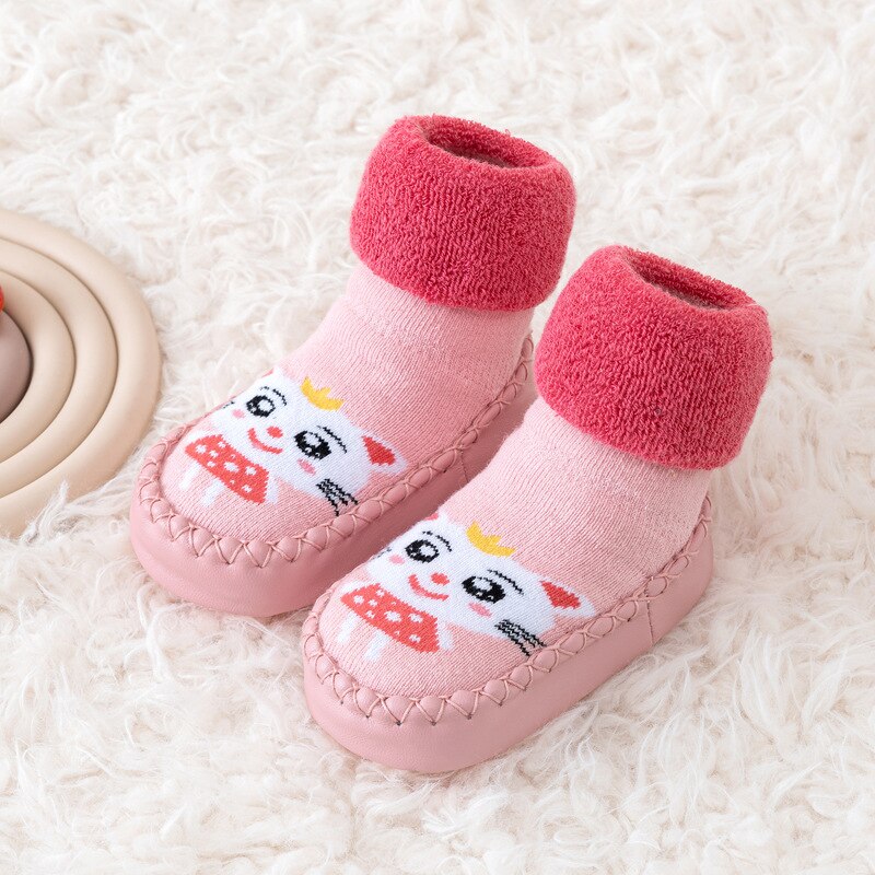 Baby socks shoes in soft canvas, color-matched, offering warmth and stability for little feet.