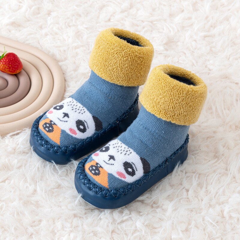 Pair of unisex baby walking shoes with soft soles and canvas material, comfortable for crawling babies.