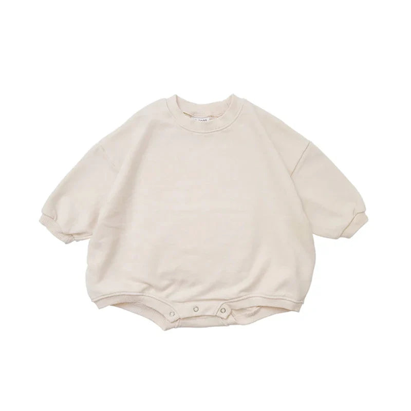Flat lay of a folded short sleeve infant romper, breathable cotton for active babies