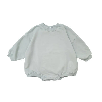 Soft fabric detail of a unisex oversized baby jumpsuit, ensuring comfort for delicate skin