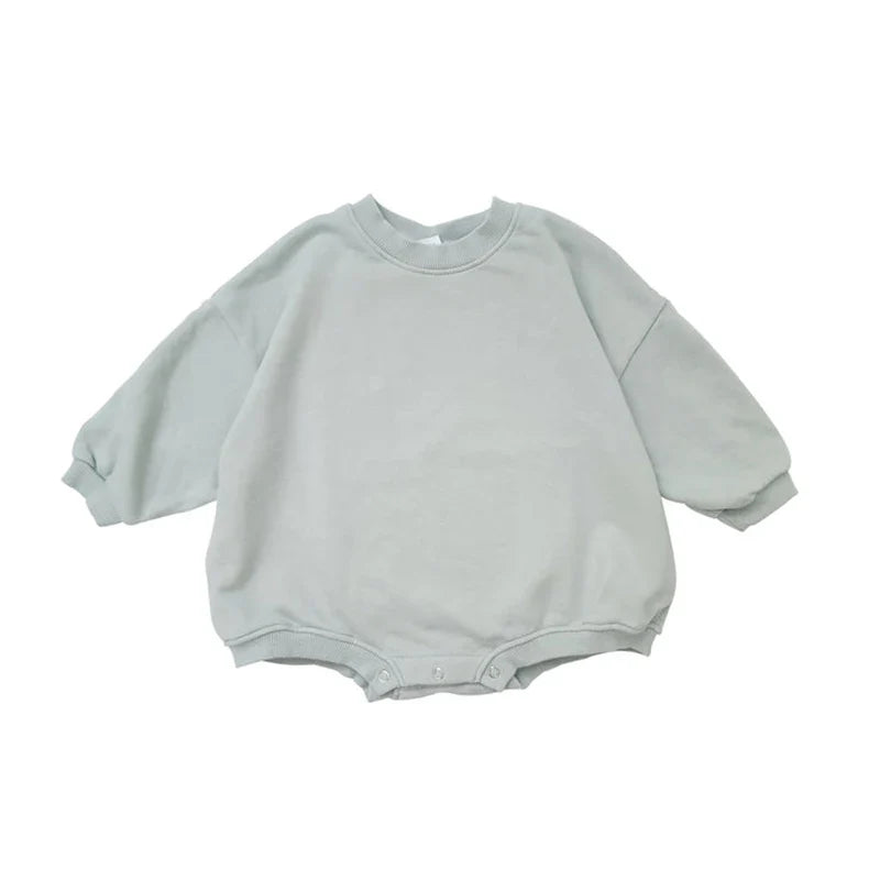 Close-up of the soft fabric texture of a unisex infant cotton romper, ideal for toddlers