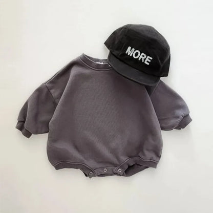 Detailed shot of the durable snap buttons on a unisex baby romper for quick changes