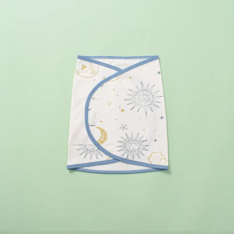Newborn baby sleeping soundly, secured in a breathable cotton swaddle for optimal belly protection