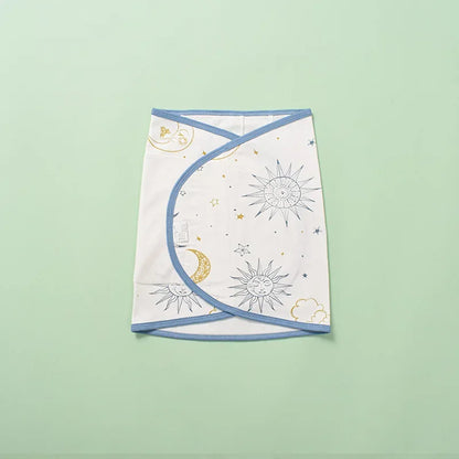 Newborn baby sleeping soundly, secured in a breathable cotton swaddle for optimal belly protection