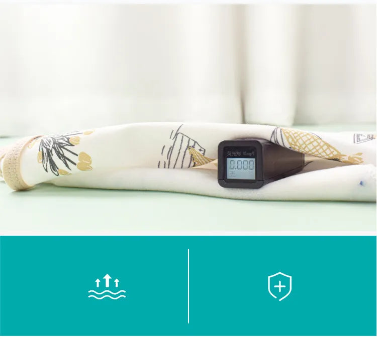 Newborn peacefully sleeping in a blue cotton swaddle, highlighting effective belly protection
