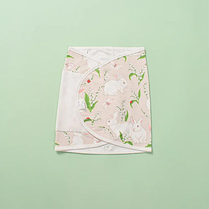 Unisex baby swaddle in a charming polka dot pattern, ideal infant wrap for secure belly comfort