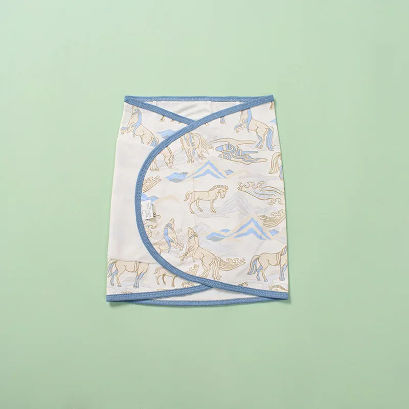 Close-up of fabric texture on a soft grey cotton swaddle, emphasizing baby comfort & belly protection