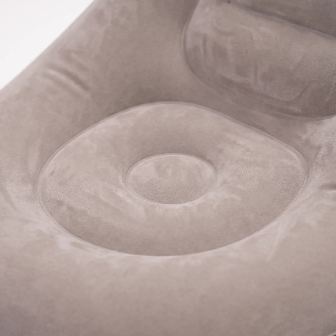 Comfortable inflatable lounge chair with ottoman footrest, perfect for relaxing sunbathing or indoor seating.