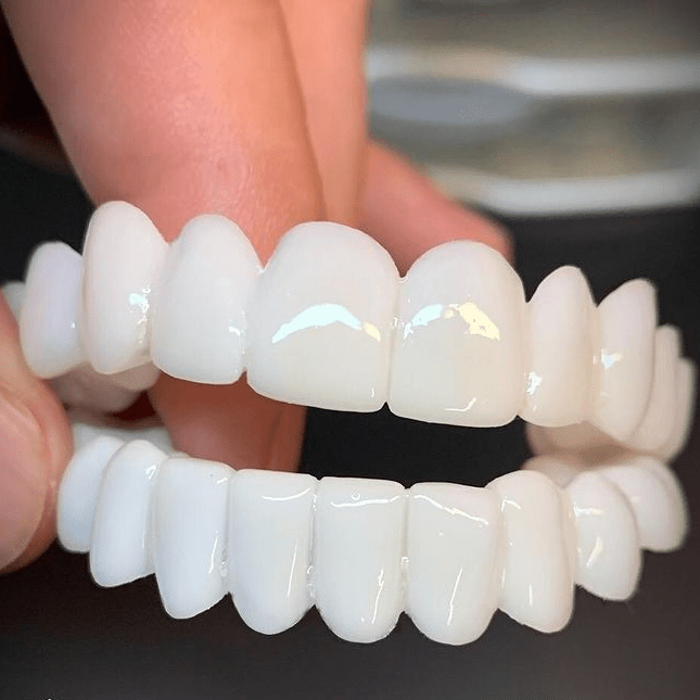 Unisex instant smile enhancer cosmetic tooth covers for bright white teeth.