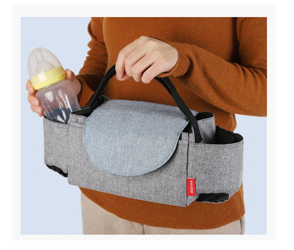 Unisex diaper bag, inside view of insulated pocket keeping milk bottle warm, essential for baby.