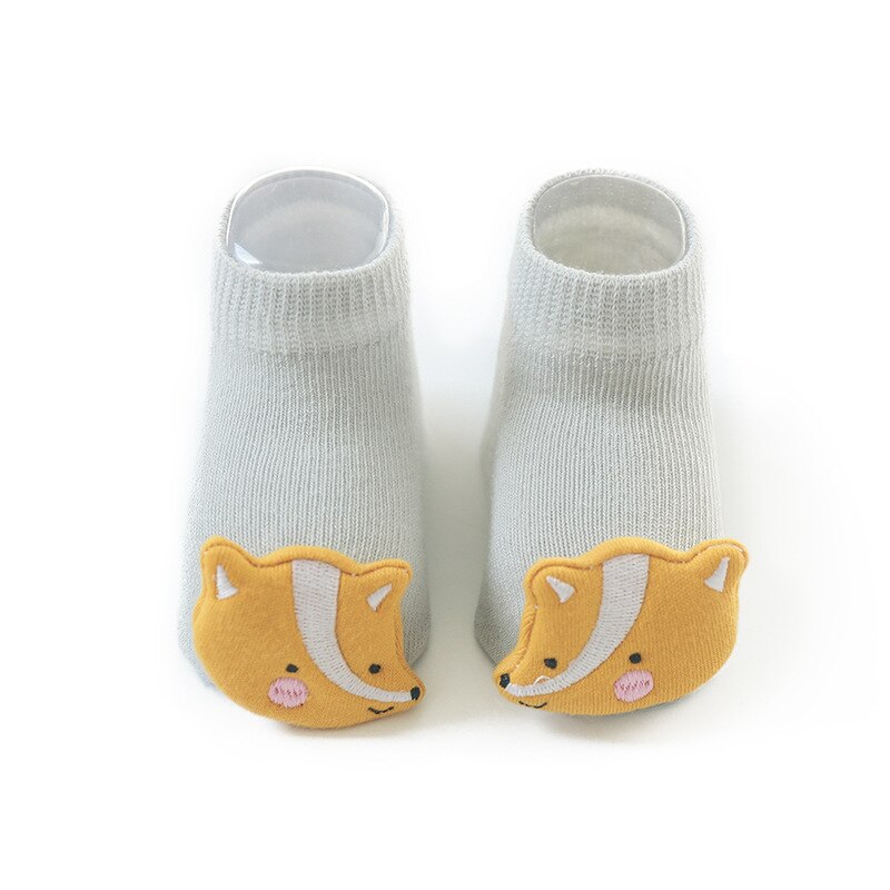 Close-up of the anti-slip grip on the sole of an infant walking sock, cotton material.