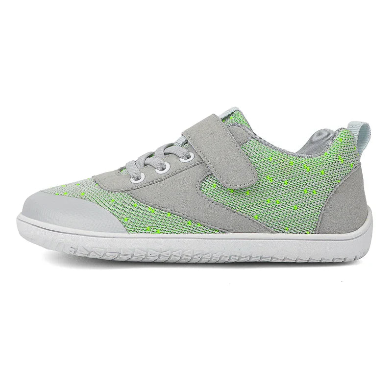 Pair of colorful barefoot sneakers for children, highlighting their flexible, lightweight build.