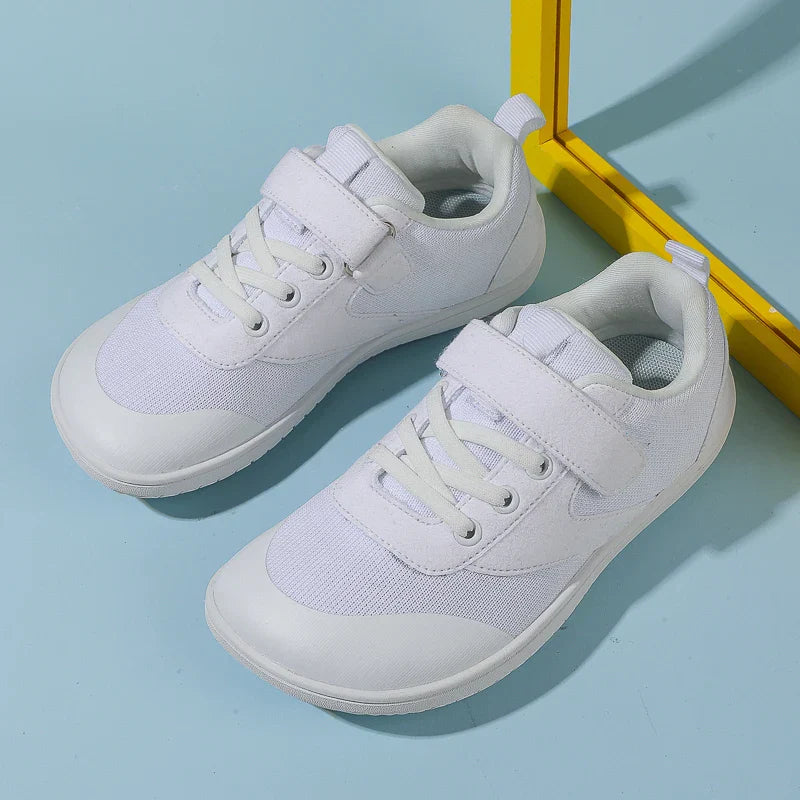 Unisex kids' barefoot running sneakers in bright orange, designed for comfort and flexibility.