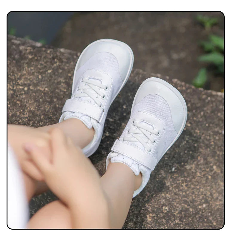 Youth barefoot lightweight shoes in a understated beige, offering freedom of movement.
