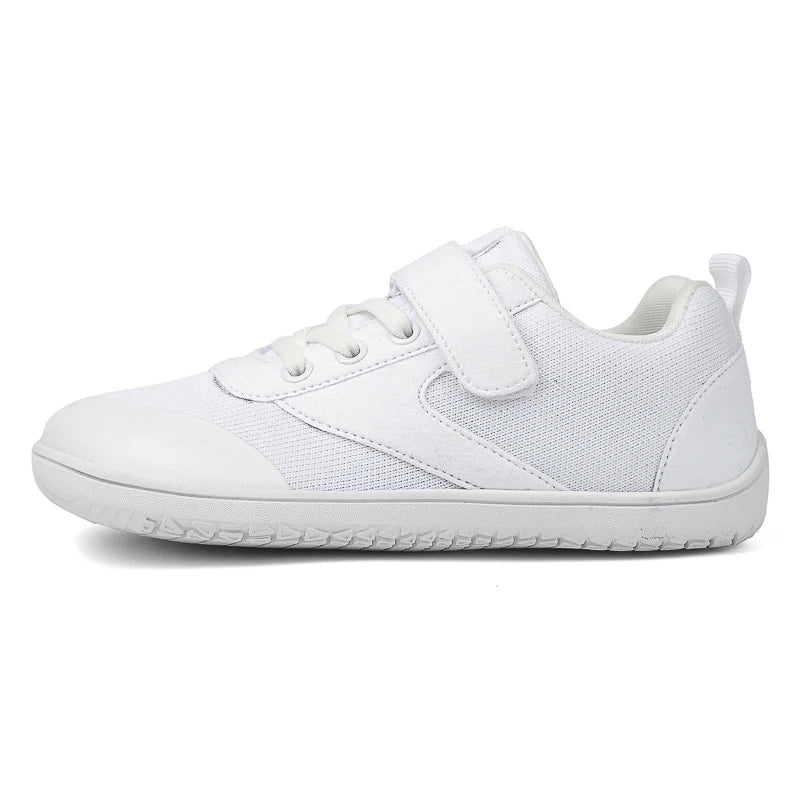 Close-up of the breathable mesh on black unisex kids' barefoot shoes, showing flexible sole.