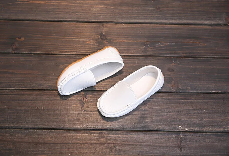 Unisex youth slip-on loafers with a clean, simple design. Breathable fabric for active wear.