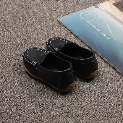 Side view of a unisex youth slip-on loafer, showcasing its anti-slip sole and casual design. Kids shoes.