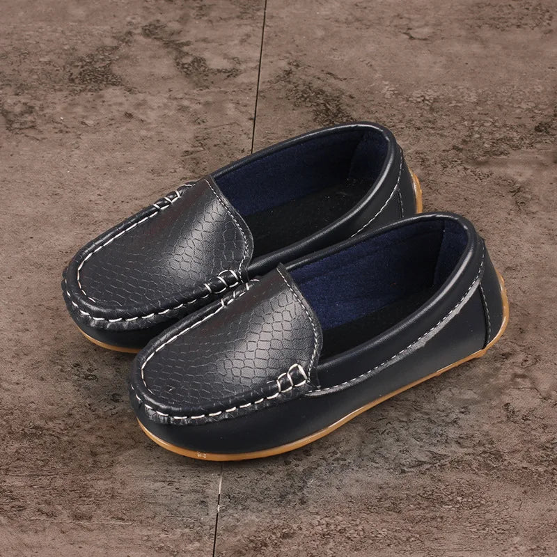Top-down view of breathable kids' slip-on loafers, ideal for active children. Unisex footwear.