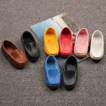 Unisex kids' slip-on loafer in a vibrant color, made with breathable material. Stylish children's shoes.