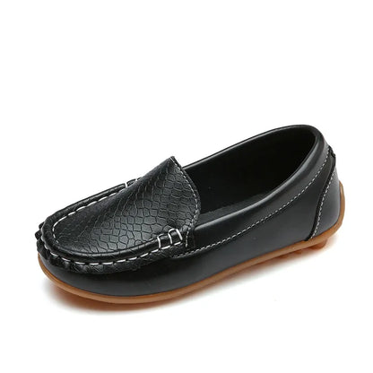 Child wearing breathable slip-on loafers, walking on a pavement. Youth footwear, anti-slip.