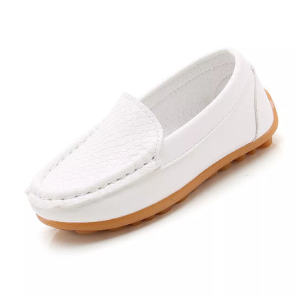 Detail of the breathable mesh fabric on a unisex kids' slip-on loafer. Casual children's shoes.