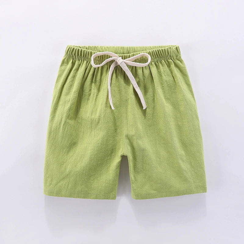 Unisex kids candy color summer shorts modeled, showing high-waisted elastic fit
