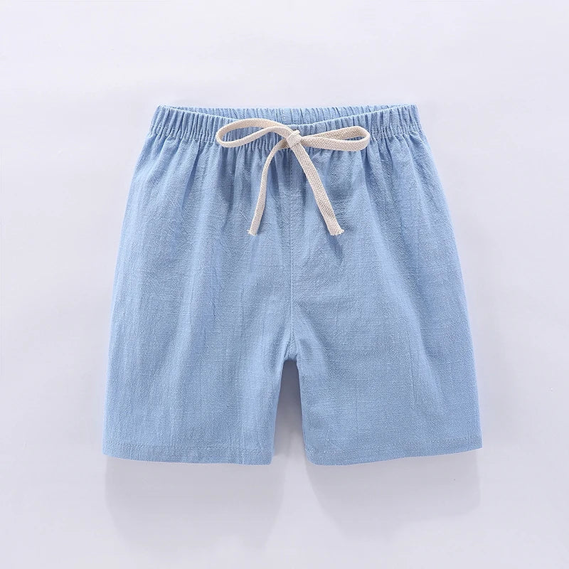 Stack of colorful unisex kids high-waisted summer shorts in various candy tones