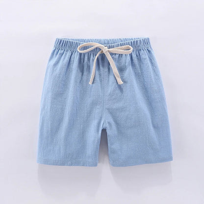 Stack of colorful unisex kids high-waisted summer shorts in various candy tones