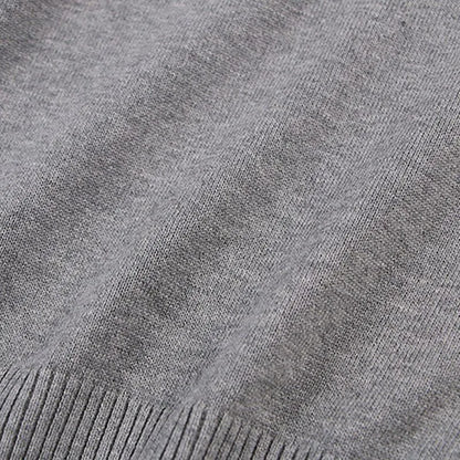 Happy child in a Unisex chunky cable knit pullover, cozy fall fashion