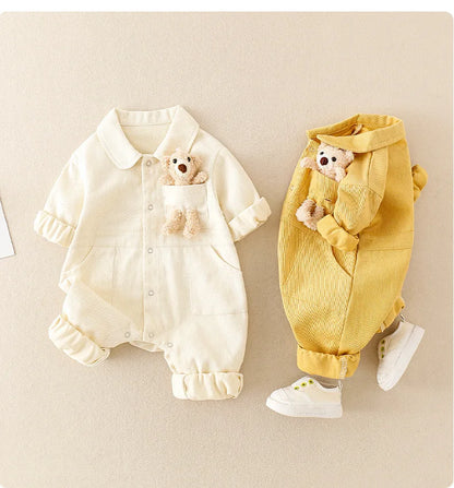Toddler in stylish denim jumpsuit, close-up of durable fabric and comfortable design, unisex kids' fashion.