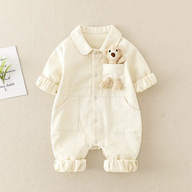 Back view of a unisex toddler denim jumpsuit, showcasing adjustable straps and spacious fit for growth.