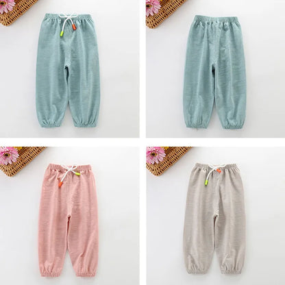 Unisex kids cotton breathable summer pants, dark grey, paired with a white t-shirt, casual style