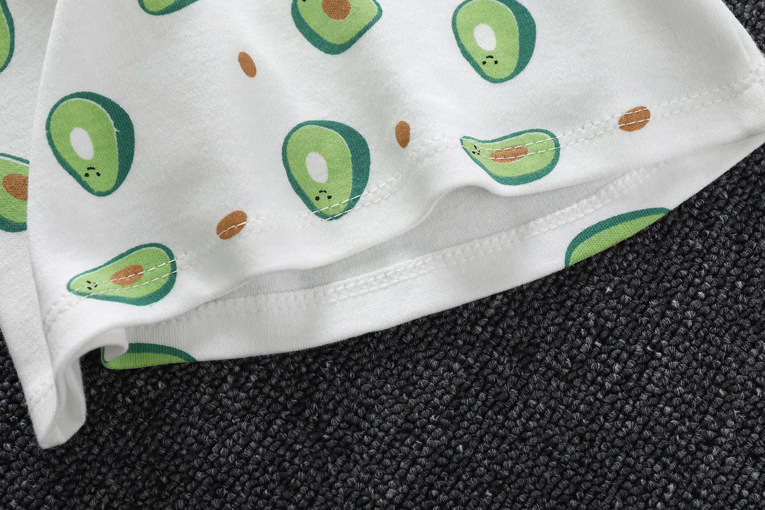 Infant pajama set, unisex and cotton, with a playful cartoon pattern on light background