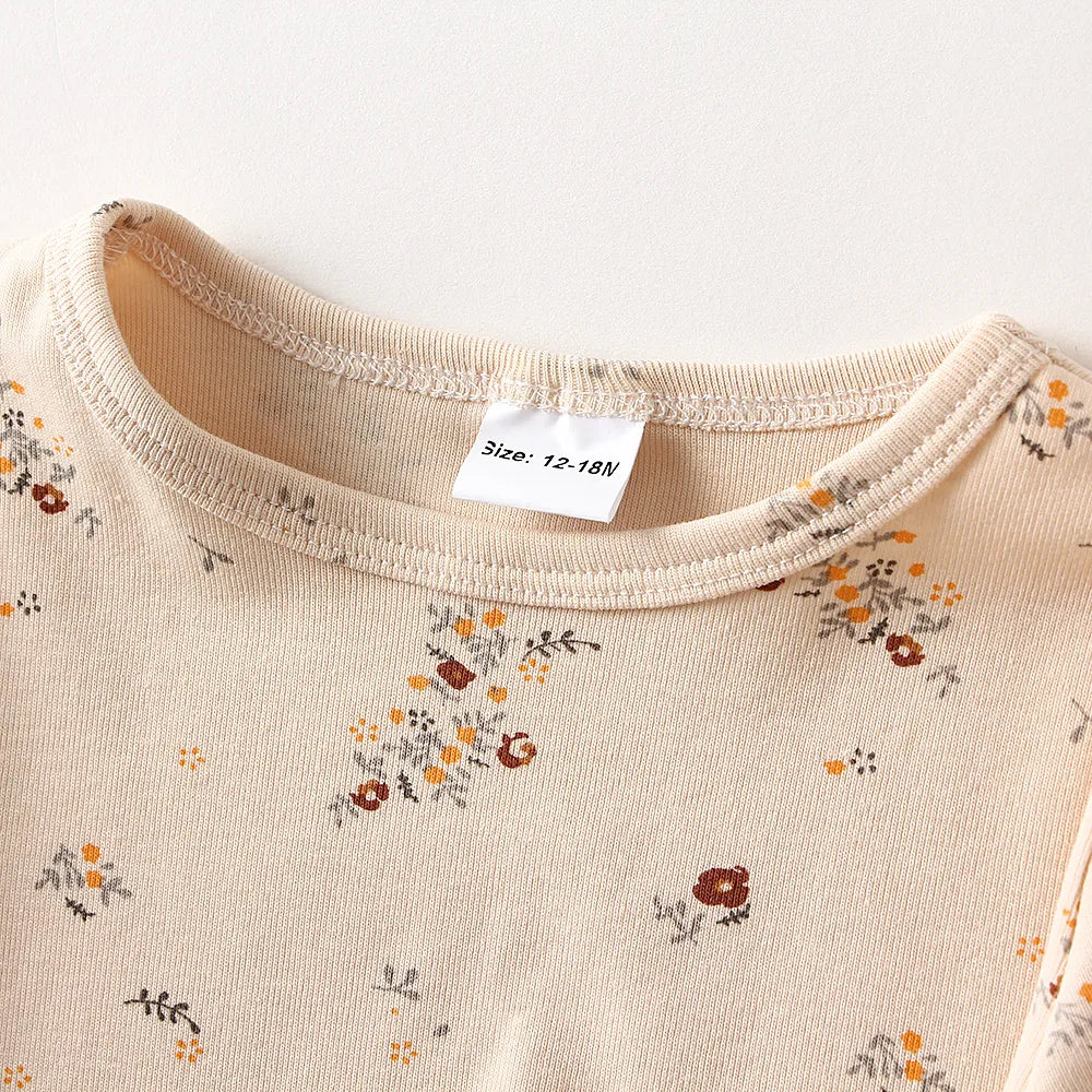 Toddler-sized unisex cotton long-sleeve pajamas in a gentle grey with tiny polka dots, for cozy sleep.