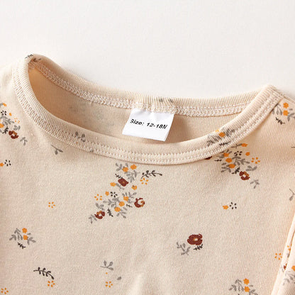 Toddler-sized unisex cotton long-sleeve pajamas in a gentle grey with tiny polka dots, for cozy sleep.