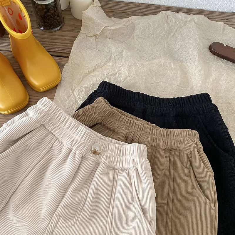 Model shot of a child demonstrating comfort of unisex kids winter corduroy pants