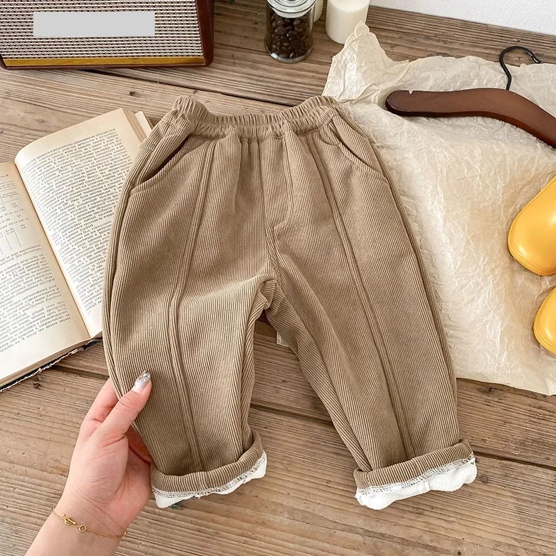 Studio shot of unisex kids fleece-lined corduroy winter pants on white background
