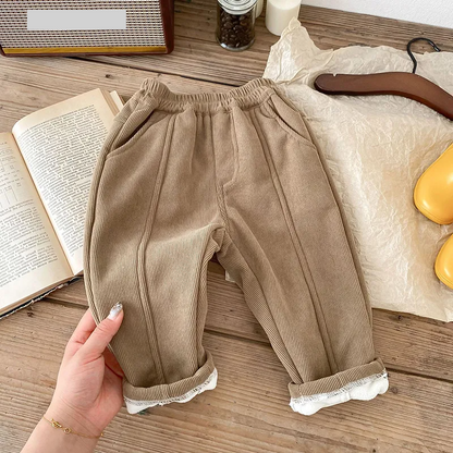 Studio shot of unisex kids fleece-lined corduroy winter pants on white background