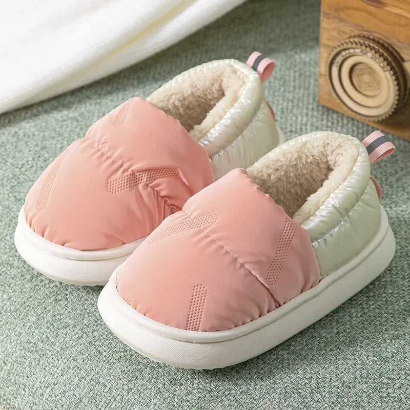 Various colors of unisex kids fleece-lined anti-slip winter slippers, highlighting their cozy design.