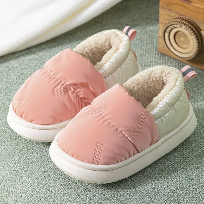Various colors of unisex kids fleece-lined anti-slip winter slippers, highlighting their cozy design.